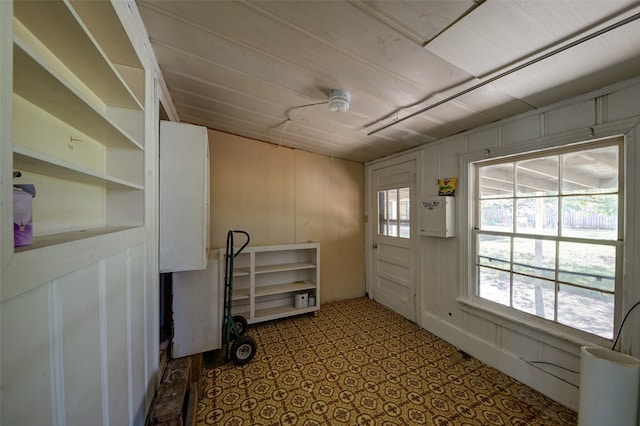 entryway with wood walls