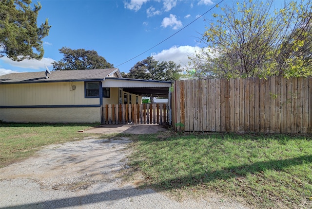 view of home's exterior featuring a yard and a carport