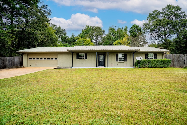 ranch-style home featuring a garage and a front yard