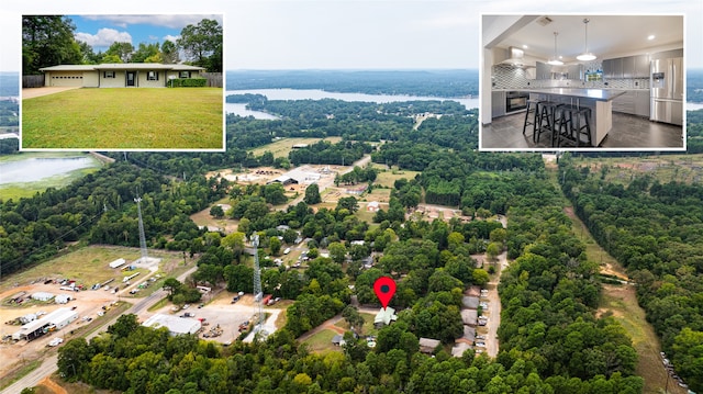 birds eye view of property featuring a water view