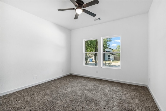 carpeted spare room featuring ceiling fan