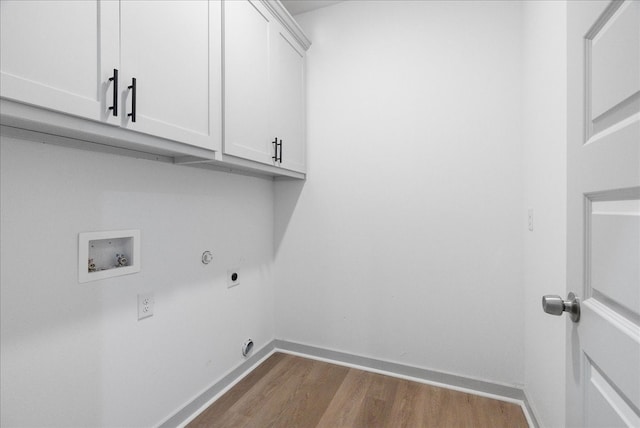 clothes washing area featuring hookup for an electric dryer, hookup for a washing machine, hookup for a gas dryer, cabinets, and light hardwood / wood-style floors