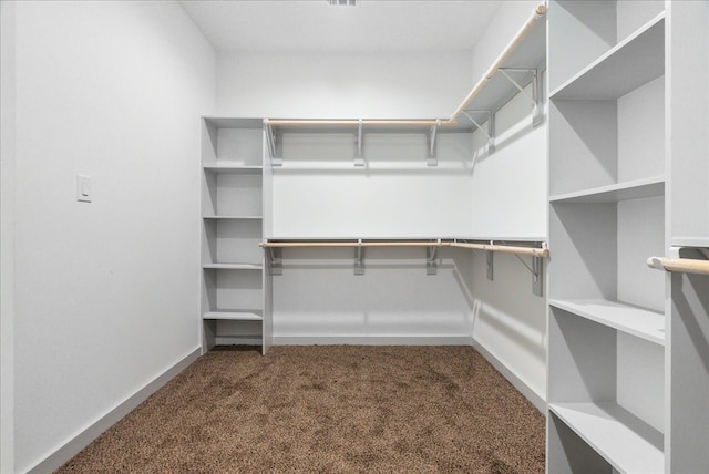 spacious closet with dark carpet