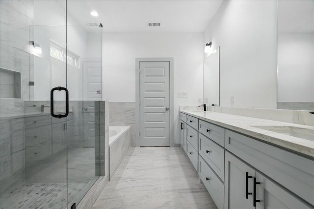 bathroom with vanity and separate shower and tub