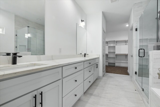 bathroom featuring vanity and a shower with door