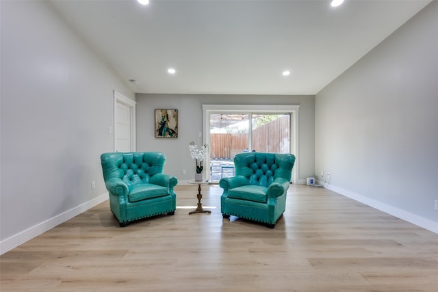 living area featuring light hardwood / wood-style flooring and lofted ceiling