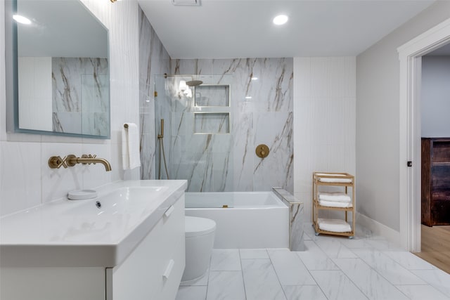 full bathroom with toilet, tiled shower / bath combo, vanity, and tile walls