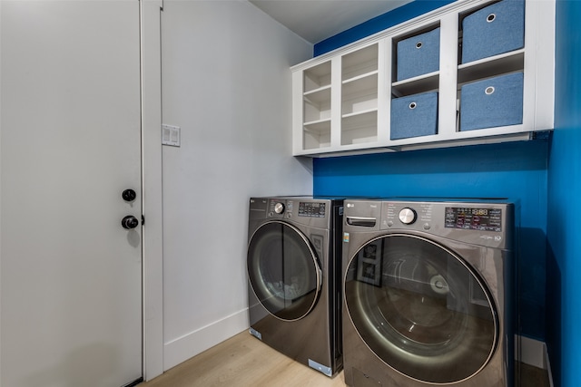 laundry area featuring light hardwood / wood-style floors and washing machine and clothes dryer