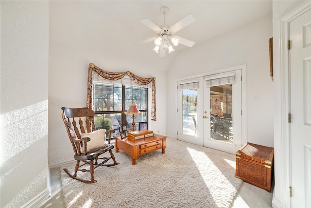 living area featuring french doors, light carpet, ceiling fan, and vaulted ceiling