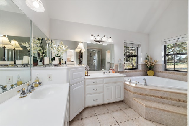 bathroom with plus walk in shower, vanity, tile patterned floors, and vaulted ceiling