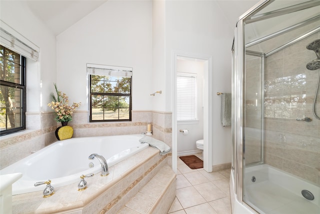 bathroom featuring toilet, a wealth of natural light, vaulted ceiling, and separate shower and tub