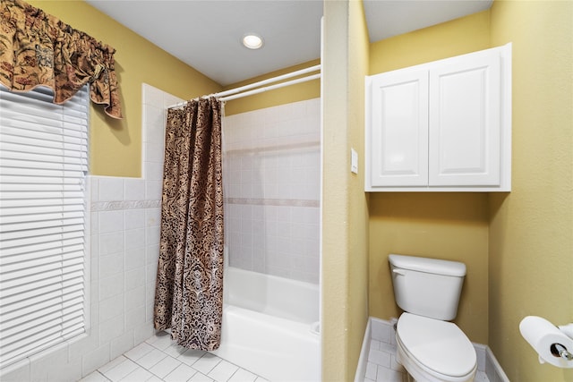 bathroom with tile patterned flooring, toilet, and shower / tub combo