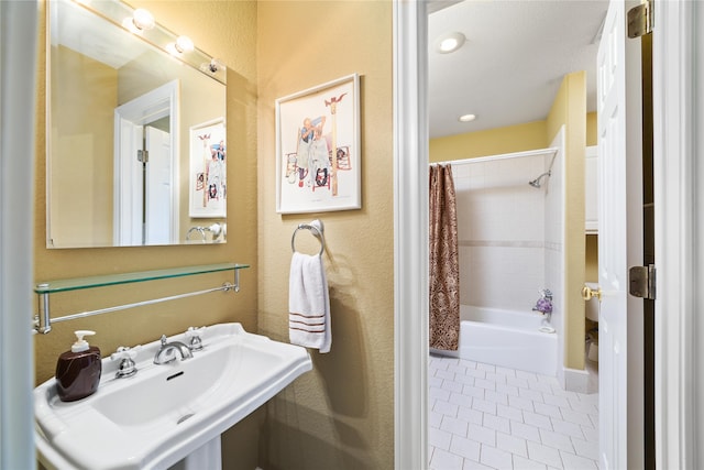 bathroom featuring tile patterned flooring, sink, and shower / tub combo