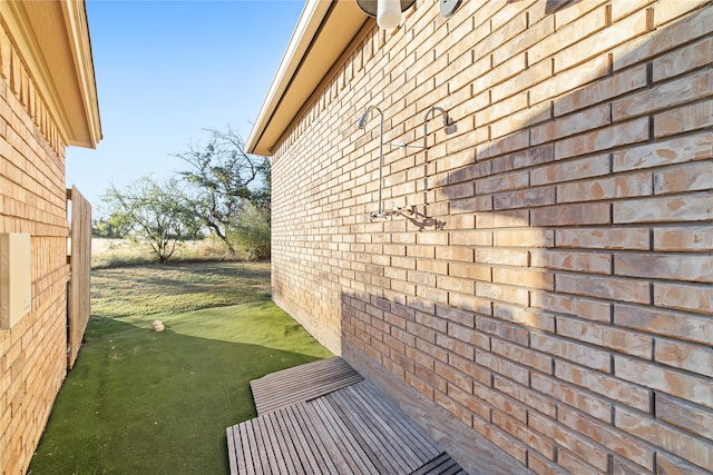 view of side of home featuring a yard