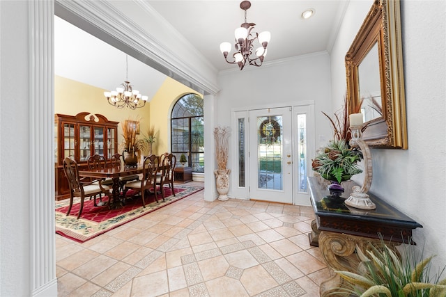 tiled foyer entrance with a chandelier and ornamental molding