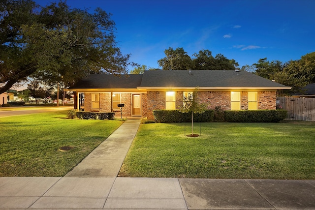 ranch-style house with a lawn