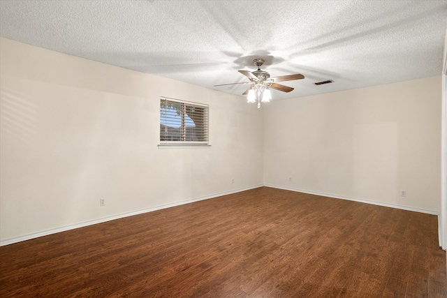 empty room with dark wood-type flooring, ceiling fan, and a textured ceiling