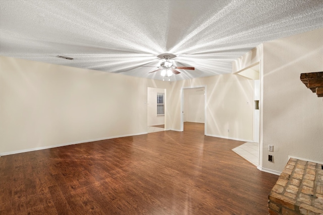 spare room featuring dark hardwood / wood-style flooring, a textured ceiling, and ceiling fan