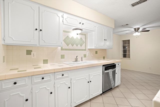 kitchen featuring white cabinetry, sink, backsplash, tile counters, and dishwasher