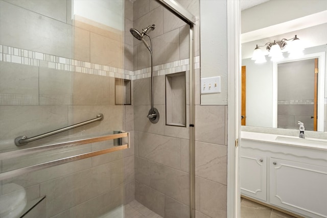 bathroom featuring vanity, tile patterned flooring, and a shower with shower door