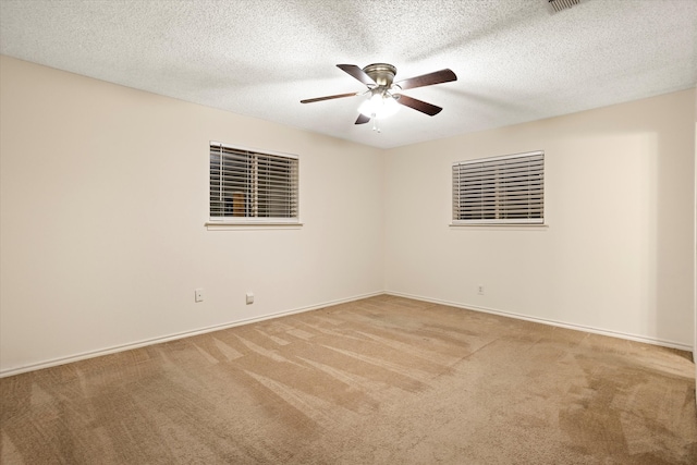 unfurnished room with ceiling fan, a textured ceiling, and carpet flooring