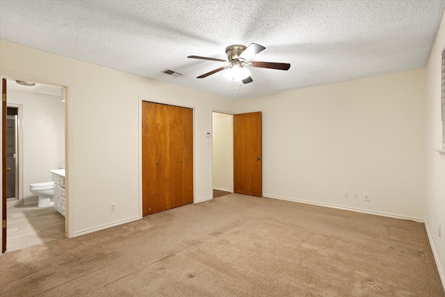 unfurnished bedroom featuring a closet, light carpet, and ceiling fan