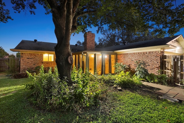 back of house featuring a lawn