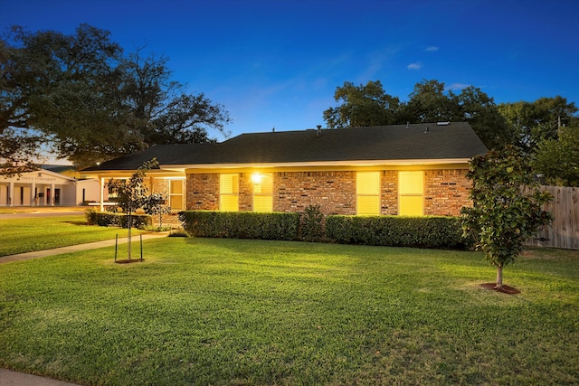 single story home featuring a front yard