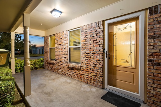 exterior entry at dusk with a porch