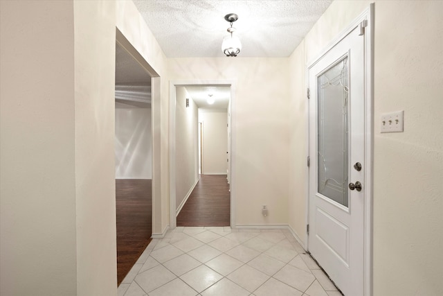 interior space with a textured ceiling and light hardwood / wood-style floors