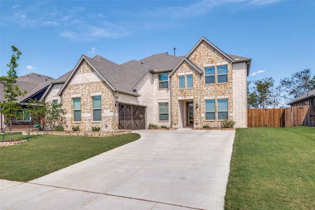 view of front of house featuring a garage and a front lawn