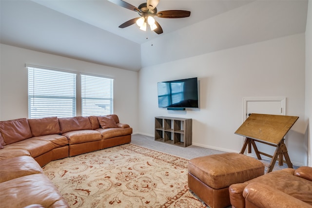 carpeted living room featuring ceiling fan and vaulted ceiling