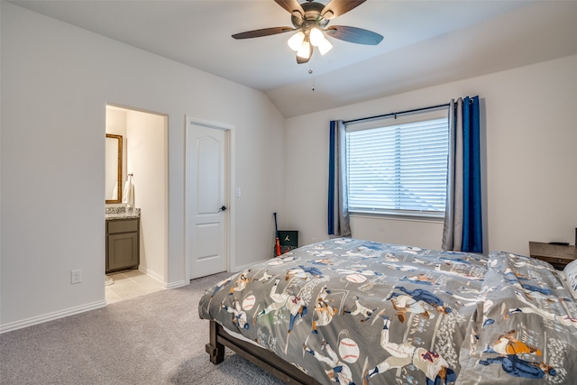 carpeted bedroom featuring lofted ceiling, ceiling fan, and ensuite bath