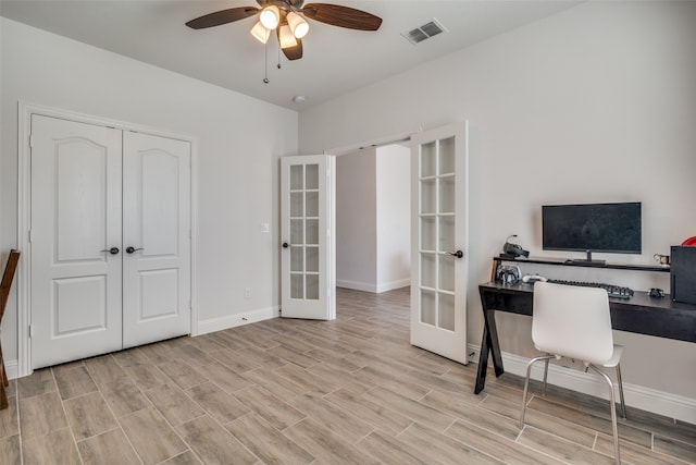 office with ceiling fan, french doors, and light hardwood / wood-style floors