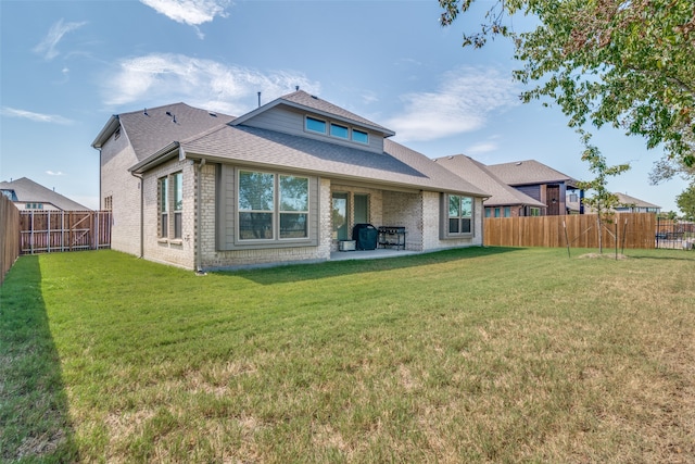 back of house with a yard and a patio area