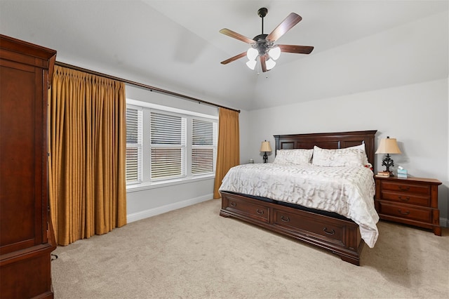 bedroom featuring vaulted ceiling, light colored carpet, and ceiling fan