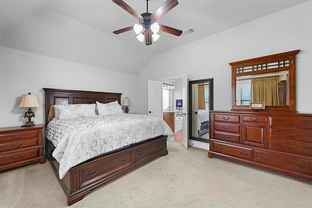 bedroom featuring connected bathroom, lofted ceiling, light carpet, and ceiling fan