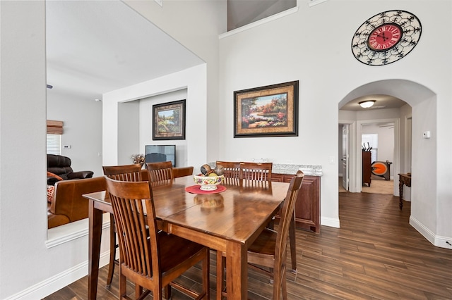 dining space with dark wood-type flooring