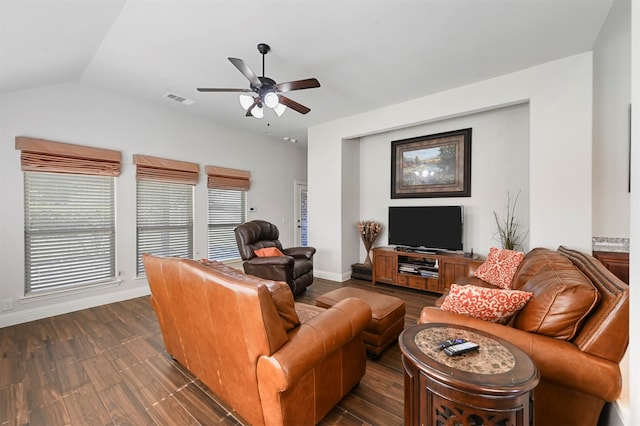 living room featuring dark hardwood / wood-style flooring, ceiling fan, and vaulted ceiling