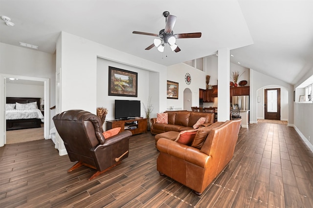 living room featuring lofted ceiling, dark wood-type flooring, and ceiling fan