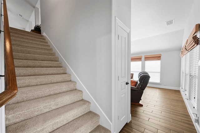 staircase featuring hardwood / wood-style floors