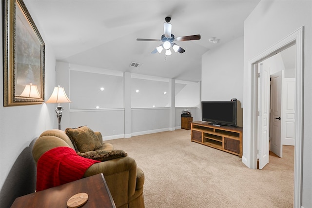 carpeted living room featuring ceiling fan and vaulted ceiling