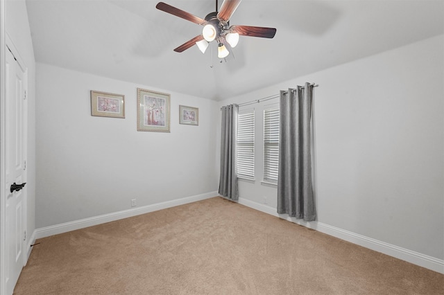 carpeted spare room featuring ceiling fan