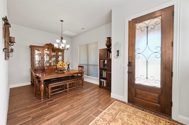 entrance foyer with plenty of natural light, hardwood / wood-style flooring, and a notable chandelier