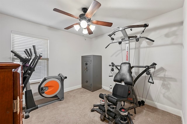 workout room with ceiling fan and light colored carpet