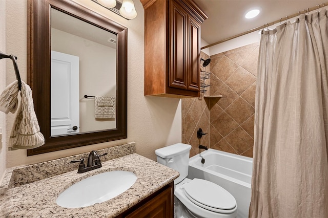 full bathroom with vanity, shower / bath combo with shower curtain, and toilet