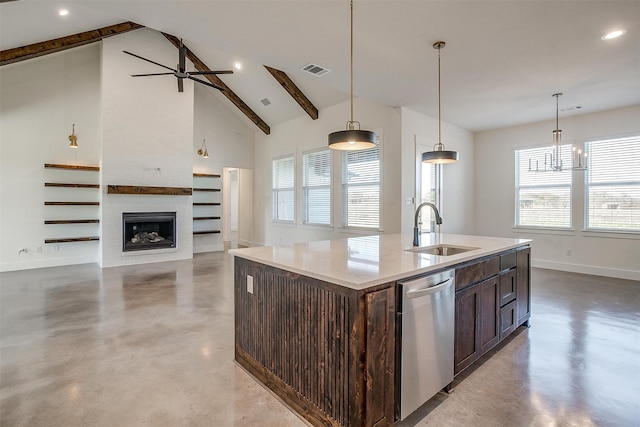 kitchen featuring pendant lighting, dishwasher, sink, a fireplace, and an island with sink