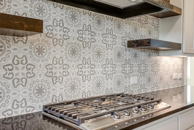 kitchen featuring premium range hood, white cabinets, and stainless steel gas stovetop