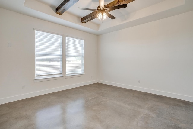 unfurnished room featuring beamed ceiling, a raised ceiling, concrete flooring, and ceiling fan