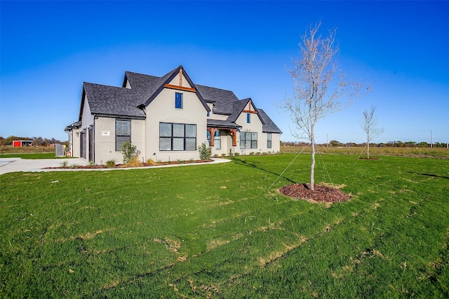 view of front of property featuring a front yard and a garage